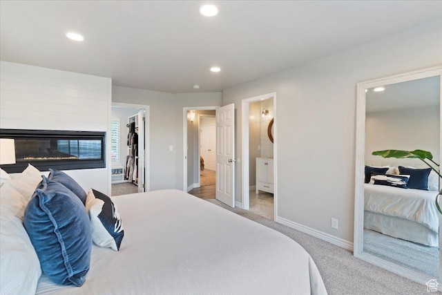 53 N Foxhill Rd N, North Salt Lake, UT 84054 - carpeted bedroom featuring recessed lighting, a spacious closet, connected bathroom, and a glass covered fireplace