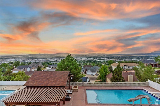 53 N Foxhill Rd N, North Salt Lake, UT 84054 - pool at dusk with a water slide, a fenced backyard, and a residential view