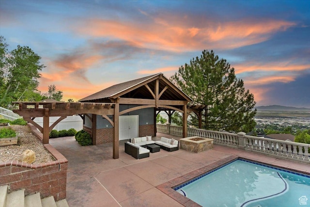 53 N Foxhill Rd N, North Salt Lake, UT 84054 - pool at dusk with an outdoor living space with a fire pit, a gazebo, and a patio