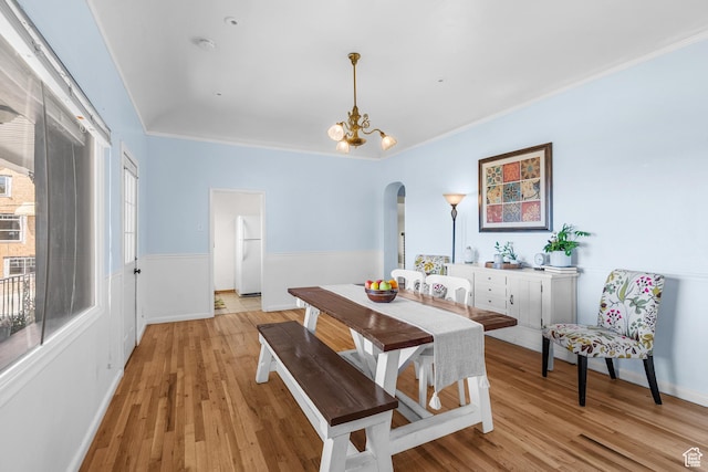 79 S 300 E, Farmington, UT 84025 - dining space with arched walkways, crown molding, a chandelier, and light wood finished floors