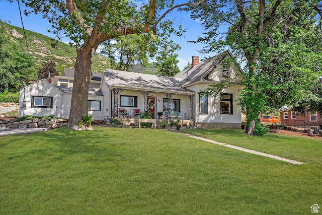 79 S 300 E, Farmington, UT 84025 - view of front of home with a porch, a front lawn, and a chimney