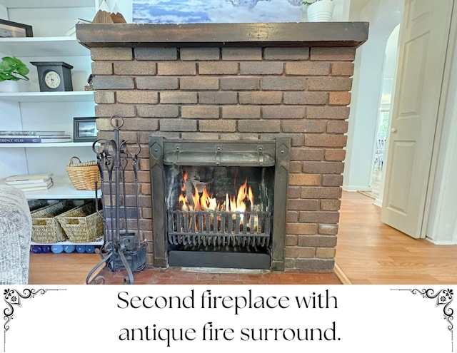 79 S 300 E, Farmington, UT 84025 - detailed view of a brick fireplace, wood finished floors, and arched walkways