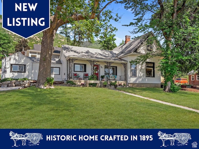 79 S 300 E, Farmington, UT 84025 - view of front of home featuring covered porch, a front lawn, and a chimney