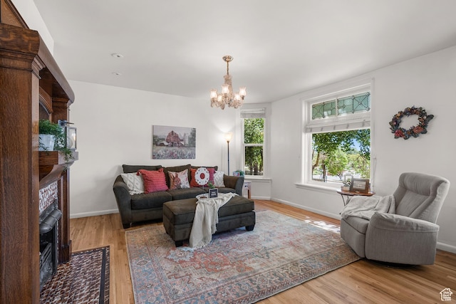 79 S 300 E, Farmington, UT 84025 - living room with a chandelier, wood finished floors, and a fireplace with flush hearth