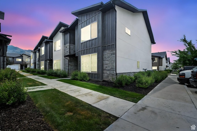 427 W 65 S, Providence, UT 84332 - property exterior at dusk featuring board and batten siding and stone siding