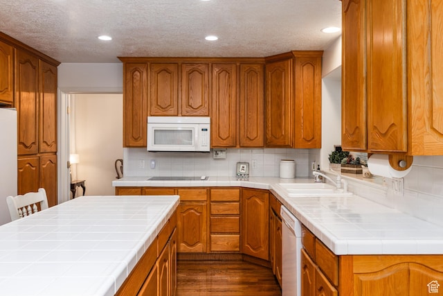 561 S Woodland Dr E, Farmington, UT 84025 - kitchen with white appliances, tile countertops, dark wood finished floors, tasteful backsplash, and brown cabinetry