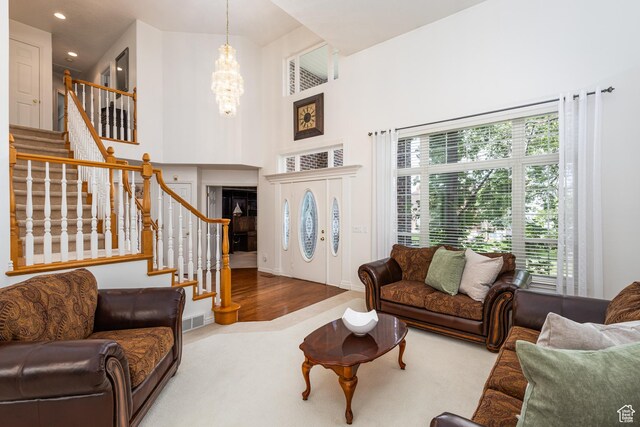 561 S Woodland Dr E, Farmington, UT 84025 - carpeted living room with a chandelier, stairs, recessed lighting, and a towering ceiling
