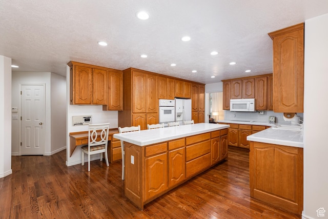 561 S Woodland Dr E, Farmington, UT 84025 - kitchen featuring white appliances, a kitchen island, dark wood finished floors, brown cabinetry, and recessed lighting