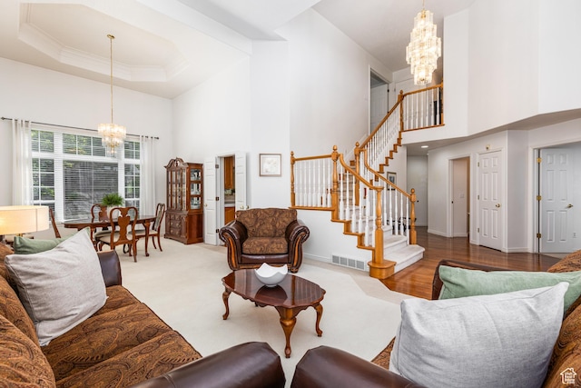 561 S Woodland Dr E, Farmington, UT 84025 - living room featuring a chandelier, a high ceiling, stairs, and ornamental molding