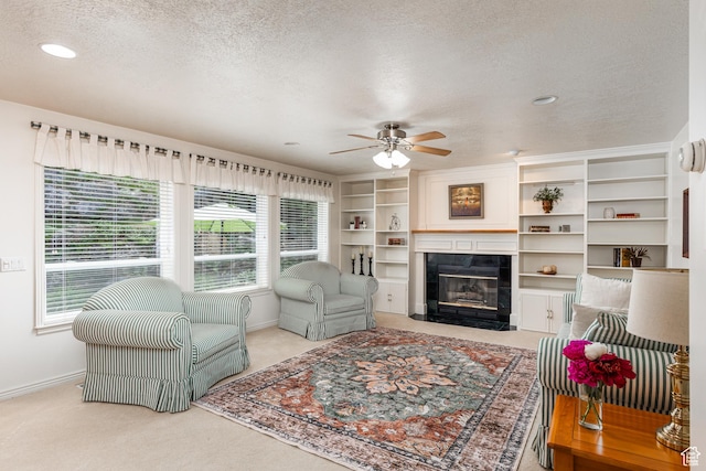561 S Woodland Dr E, Farmington, UT 84025 - living room with a textured ceiling, plenty of natural light, ceiling fan, a tile fireplace, and carpet