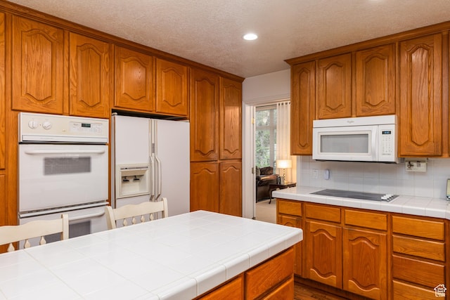 561 S Woodland Dr E, Farmington, UT 84025 - kitchen featuring white appliances, recessed lighting, backsplash, brown cabinetry, and a textured ceiling