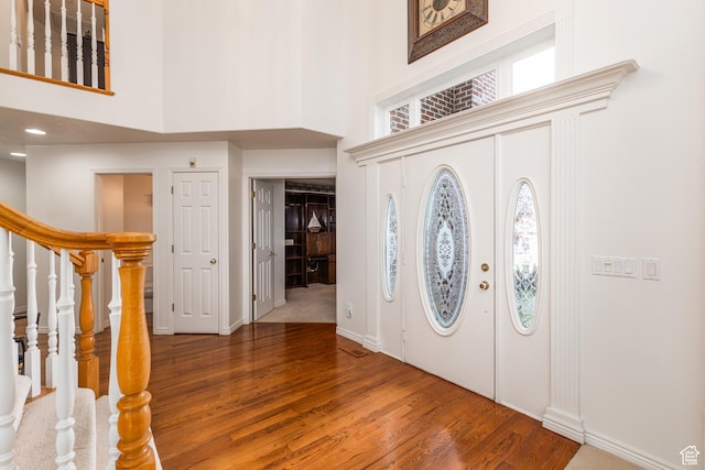 561 S Woodland Dr E, Farmington, UT 84025 - foyer entrance with a towering ceiling, wood finished floors, and stairway