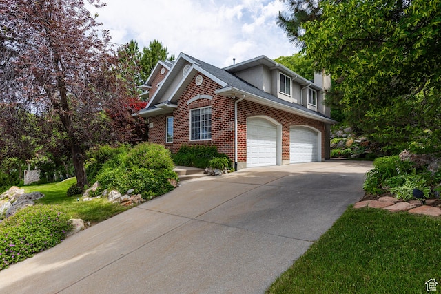 561 S Woodland Dr E, Farmington, UT 84025 - view of front of home featuring concrete driveway, brick siding, and roof with shingles
