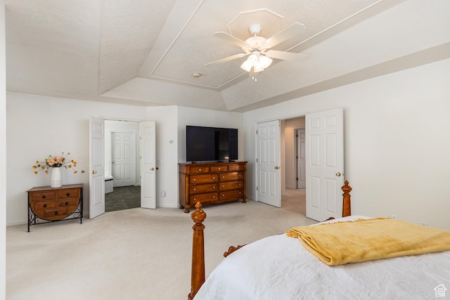 561 S Woodland Dr E, Farmington, UT 84025 - bedroom featuring light carpet, a tray ceiling, and a ceiling fan