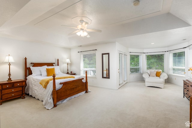 561 S Woodland Dr E, Farmington, UT 84025 - bedroom featuring a tray ceiling, carpet, multiple windows, a ceiling fan, and a textured ceiling