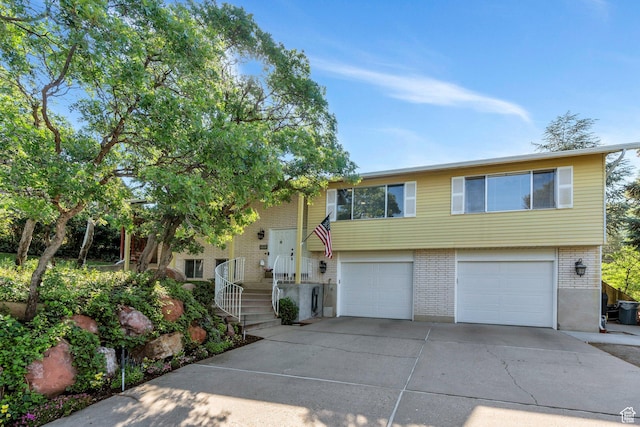 2173 S 1150 E, Bountiful, UT 84010 - view of front of property featuring brick siding, driveway, and an attached garage