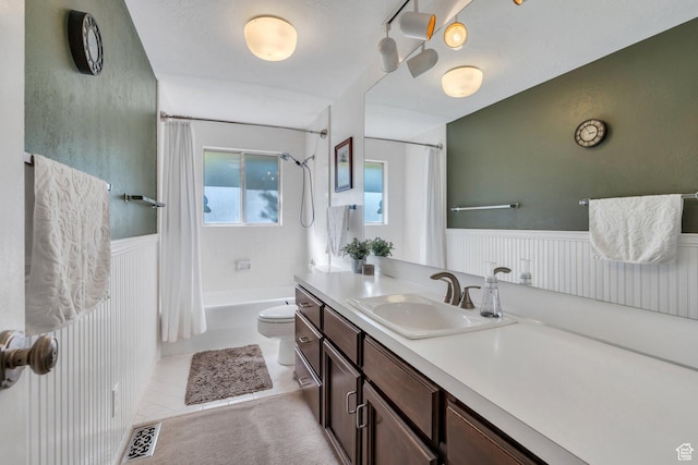 2173 S 1150 E, Bountiful, UT 84010 - bathroom featuring vanity, shower / bath combination with curtain, wainscoting, and tile patterned flooring
