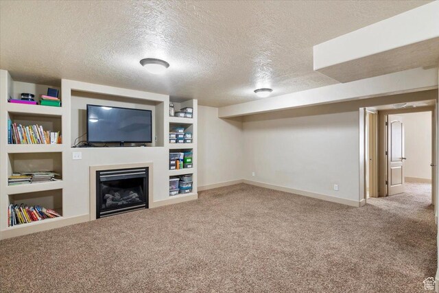 4257 W Lake Bridge Dr S, South Jordan, UT 84009 - unfurnished living room featuring carpet, a textured ceiling, a fireplace, and built in shelves
