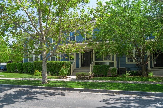 4257 W Lake Bridge Dr S, South Jordan, UT 84009 - obstructed view of property featuring a porch and a front yard