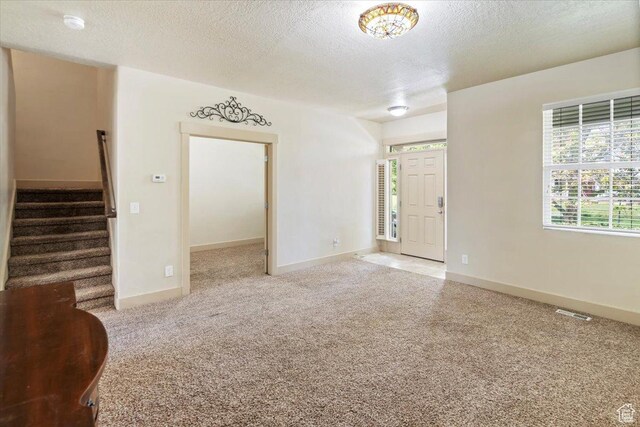 4257 W Lake Bridge Dr S, South Jordan, UT 84009 - carpeted spare room featuring stairs, a textured ceiling, and a smoke detector