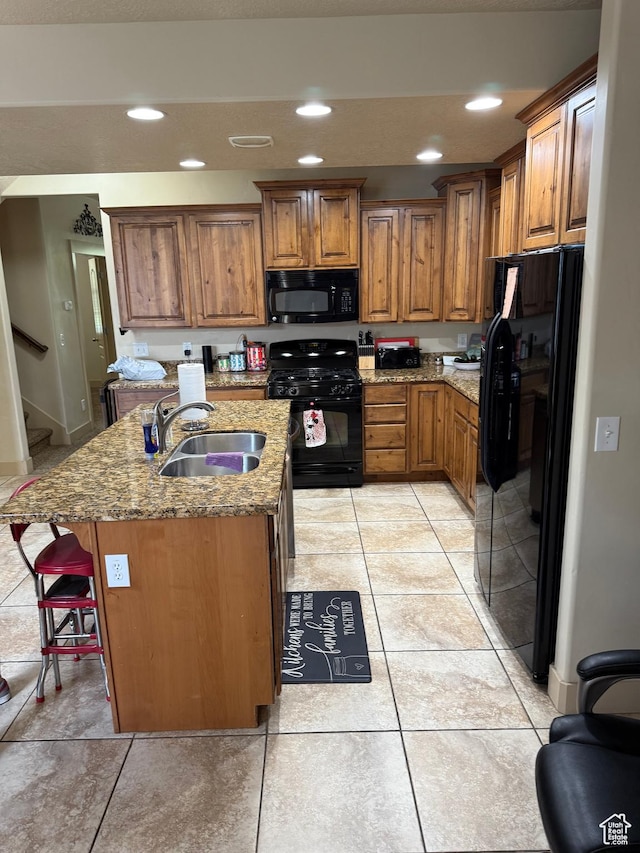 4257 W Lake Bridge Dr S, South Jordan, UT 84009 - kitchen featuring black appliances, brown cabinetry, light stone counters, a kitchen breakfast bar, and recessed lighting