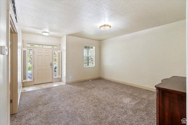 4257 W Lake Bridge Dr S, South Jordan, UT 84009 - carpeted entrance foyer featuring a textured ceiling and baseboards