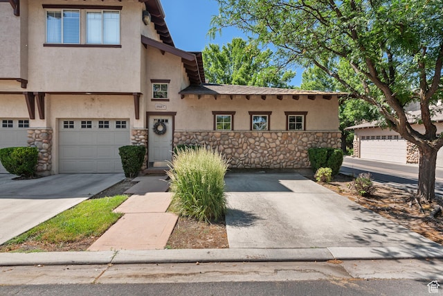 1692 E Kelmscott Ct S Unit C, Salt Lake City, UT 84124 - view of front of property featuring stone siding, stucco siding, a garage, and driveway