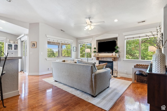 1692 E Kelmscott Ct S Unit C, Salt Lake City, UT 84124 - living area with ceiling fan, lofted ceiling, plenty of natural light, a tile fireplace, and light wood-style floors