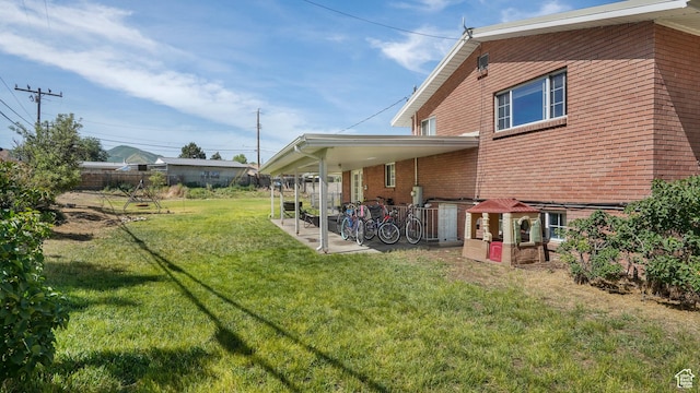 176 E Brook Ave N, Tooele, UT 84074 - back of property with a patio area and brick siding