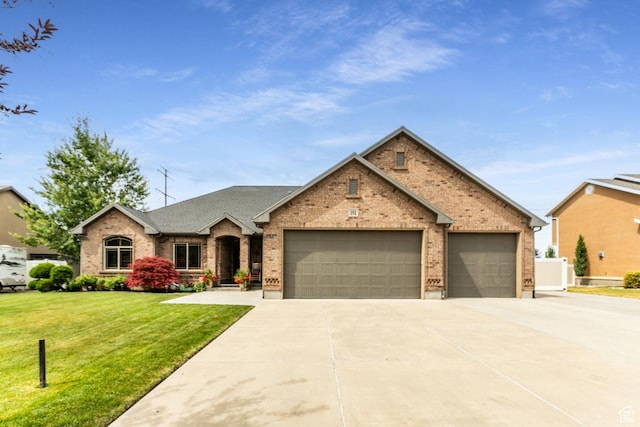 191 W Ranch Rd, Farmington, UT 84025 - view of front of home featuring brick siding, driveway, a garage, and a front yard