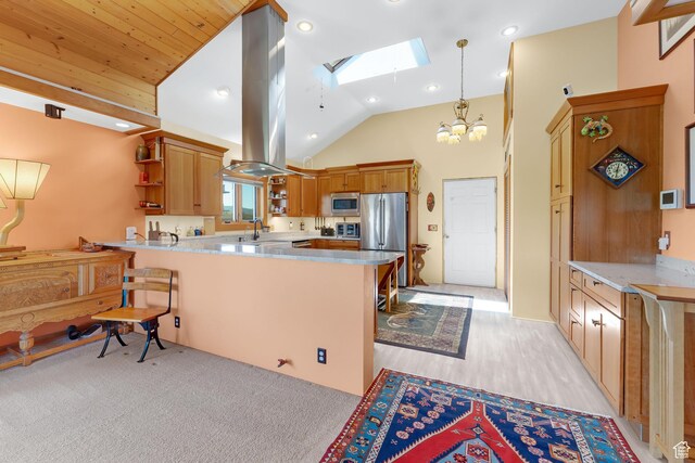 966 Mill Rd, Evanston, WY 82930 - kitchen with open shelves, appliances with stainless steel finishes, a skylight, a peninsula, and vaulted ceiling