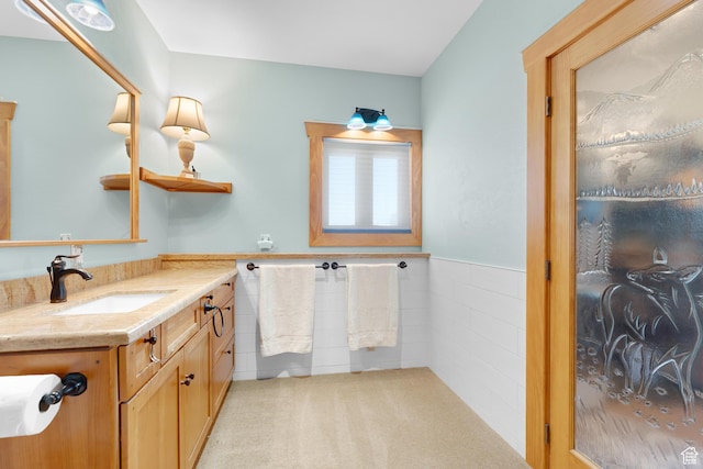 966 Mill Rd, Evanston, WY 82930 - bathroom with vanity, wainscoting, and tile walls