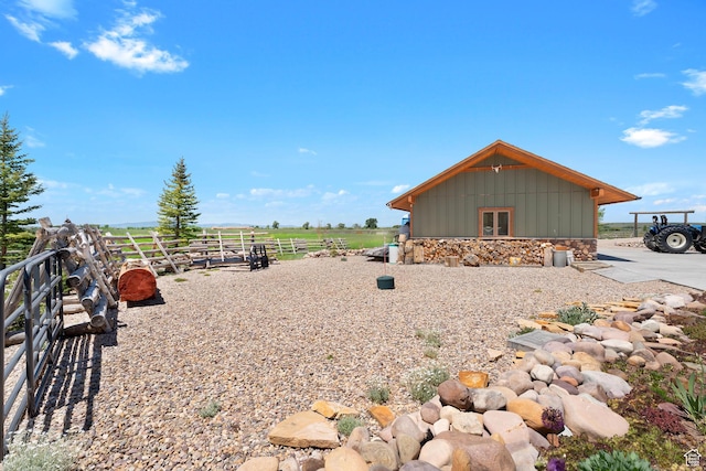 966 Mill Rd, Evanston, WY 82930 - view of property exterior with board and batten siding, stone siding, and a view of countryside
