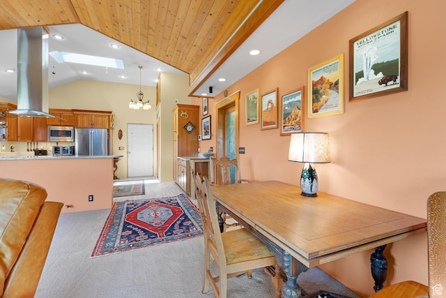 966 Mill Rd, Evanston, WY 82930 - dining area featuring a skylight, vaulted ceiling, a chandelier, wooden ceiling, and light carpet