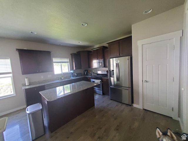4973 E Oakwood Dr, Eagle Mountain, UT 84005 - kitchen with appliances with stainless steel finishes, a kitchen island, dark brown cabinetry, dark wood-style floors, and recessed lighting