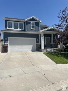 4973 E Oakwood Dr, Eagle Mountain, UT 84005 - view of front of home featuring an attached garage and concrete driveway