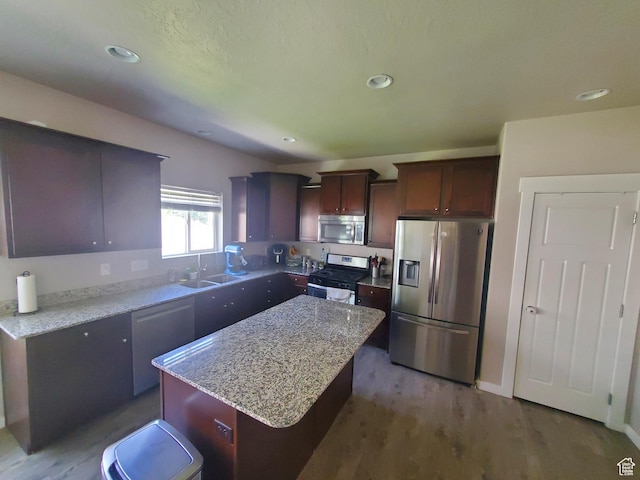 4973 E Oakwood Dr, Eagle Mountain, UT 84005 - kitchen featuring stainless steel appliances, a kitchen island, dark wood finished floors, light stone countertops, and recessed lighting