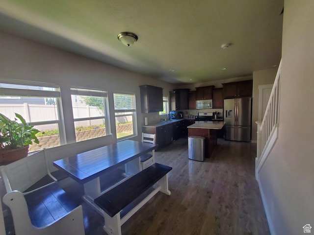 4973 E Oakwood Dr, Eagle Mountain, UT 84005 - dining area with dark wood-style floors and stairway
