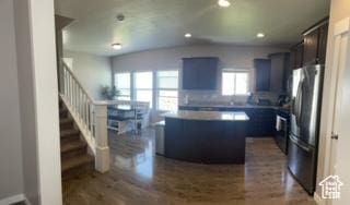 4973 E Oakwood Dr, Eagle Mountain, UT 84005 - kitchen featuring freestanding refrigerator, dark wood-style floors, a center island, recessed lighting, and vaulted ceiling