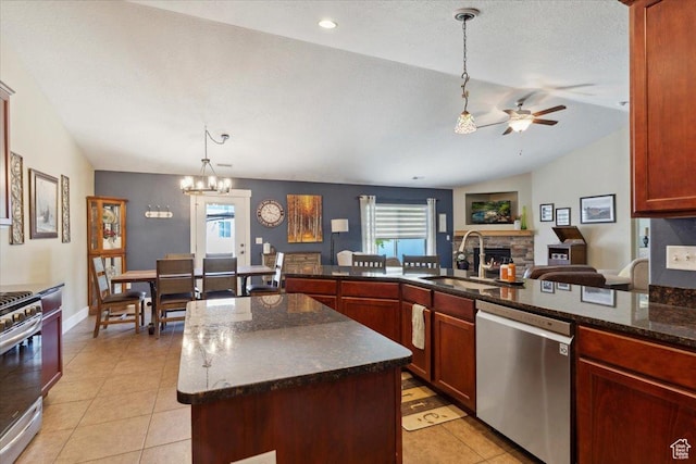 210 E 2150 N, North Ogden, UT 84414 - kitchen featuring appliances with stainless steel finishes, a ceiling fan, a fireplace, pendant lighting, and light tile patterned floors