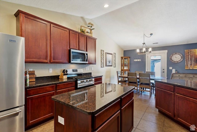 210 E 2150 N, North Ogden, UT 84414 - kitchen featuring appliances with stainless steel finishes, vaulted ceiling, a chandelier, dark stone countertops, and dark brown cabinets