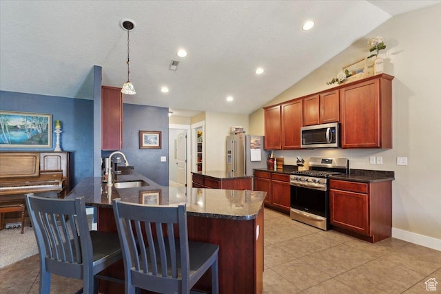 210 E 2150 N, North Ogden, UT 84414 - kitchen featuring appliances with stainless steel finishes, a peninsula, vaulted ceiling, a breakfast bar area, and decorative light fixtures
