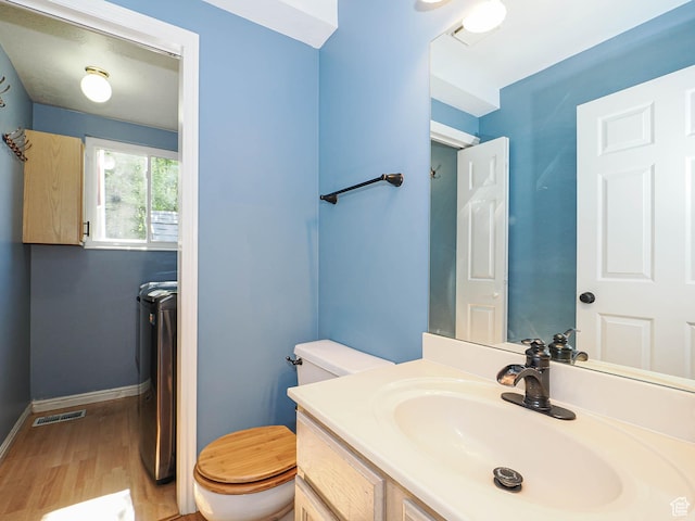 1402 E Valley Ridge Dr S, Sandy, UT 84093 - bathroom featuring wood finished floors, vanity, and washing machine and clothes dryer