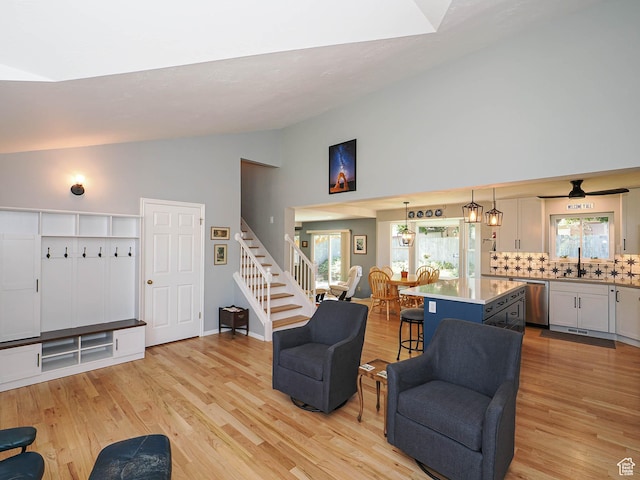 1402 E Valley Ridge Dr S, Sandy, UT 84093 - living room with light wood-type flooring, high vaulted ceiling, and stairs