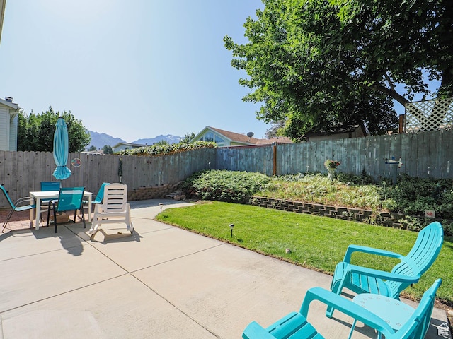 1402 E Valley Ridge Dr S, Sandy, UT 84093 - fenced backyard with a patio, a mountain view, and outdoor dining area