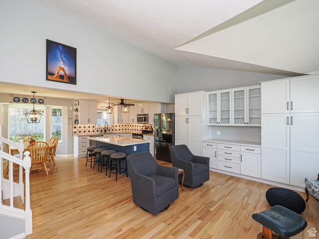 1402 E Valley Ridge Dr S, Sandy, UT 84093 - living area with a chandelier, light wood-type flooring, and high vaulted ceiling