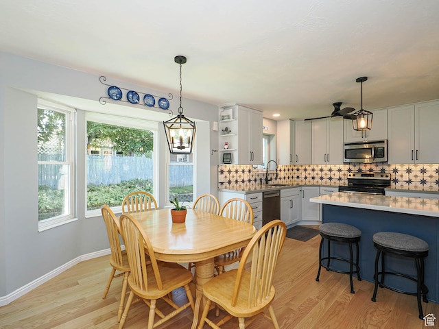 1402 E Valley Ridge Dr S, Sandy, UT 84093 - dining room with light wood-type flooring, a chandelier, and ceiling fan