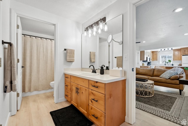 93 S 1250 E, Logan, UT 84321 - bathroom with wood finished floors, vanity, recessed lighting, and curtained shower