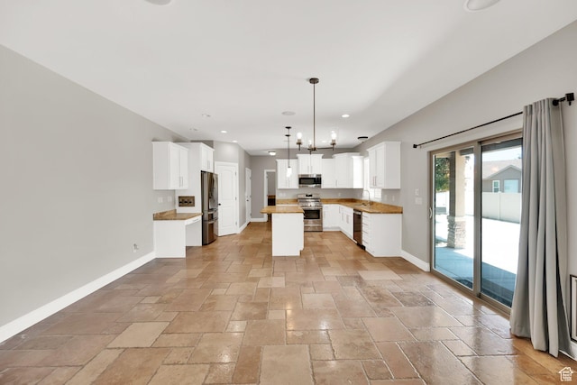 3179 W Hayden Ridge Way S, Riverton, UT 84065 - kitchen featuring appliances with stainless steel finishes, stone tile floors, recessed lighting, white cabinets, and a kitchen island