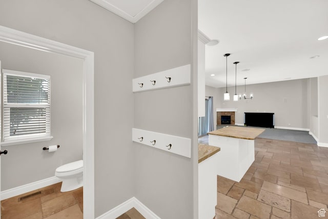 3179 W Hayden Ridge Way S, Riverton, UT 84065 - bathroom with stone tile flooring, recessed lighting, and a fireplace